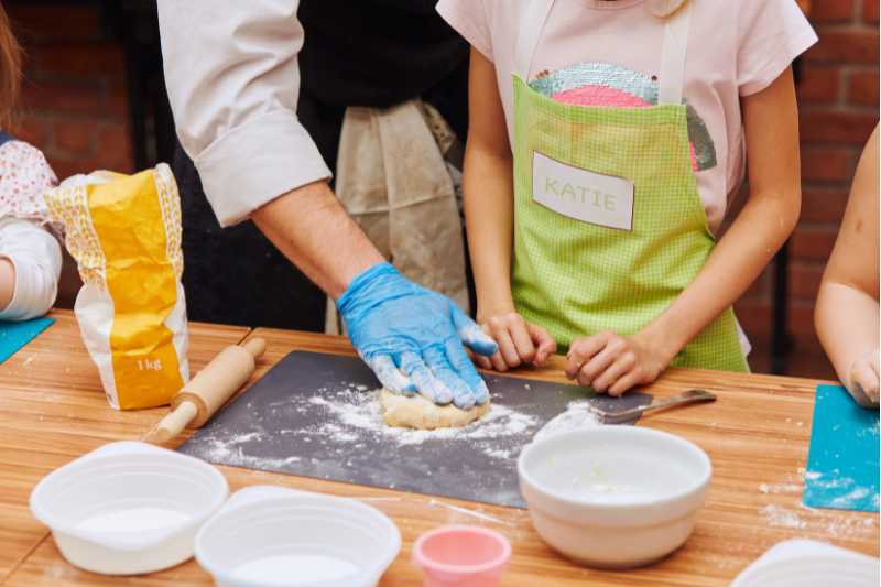 Children rolling dough